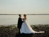 married couple on beach enjoying midweek wedding package